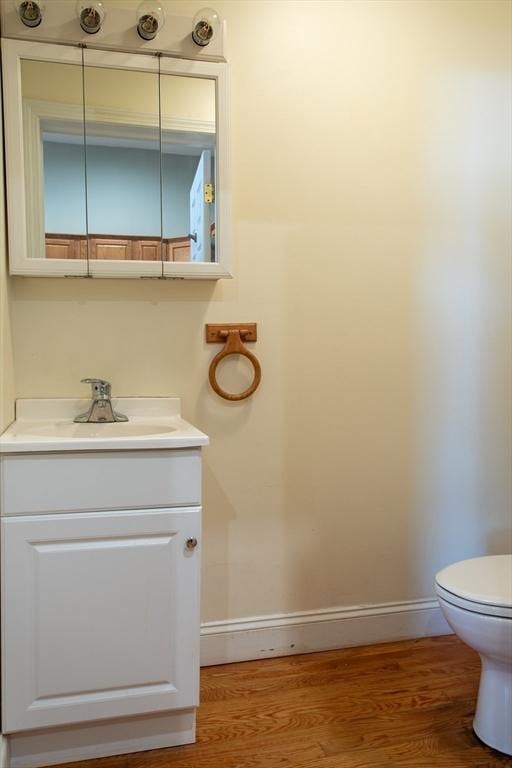 31-33 Ashland St Unit 5, Haverhill, MA 01830 - half bathroom with baseboards, toilet, vanity, and wood finished floors