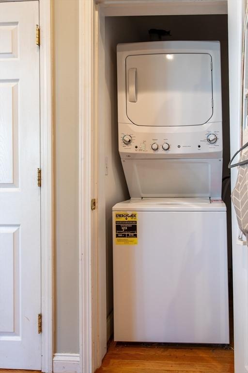 31-33 Ashland St Unit 5, Haverhill, MA 01830 - washroom with estacked washer and dryer and wood finished floors