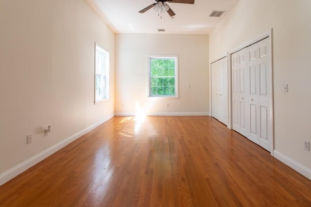 31-33 Ashland St Unit 5, Haverhill, MA 01830 - unfurnished bedroom featuring multiple closets, wood finished floors, baseboards, and a ceiling fan