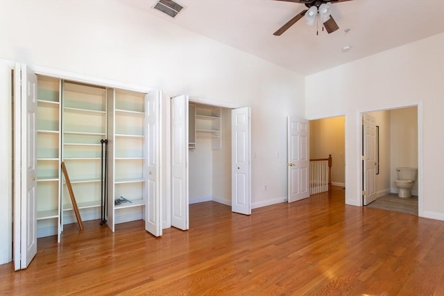 31-33 Ashland St Unit 5, Haverhill, MA 01830 - unfurnished bedroom featuring two closets, light wood-style floors, baseboards, a ceiling fan, and ensuite bath