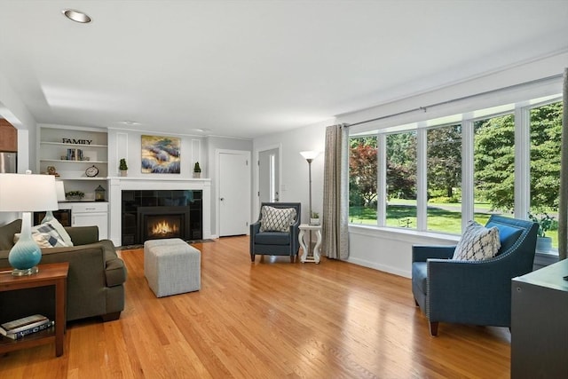 9 E Colonial Rd, Wilbraham, MA 01095 - living area with plenty of natural light, light wood-type flooring, and a tiled fireplace