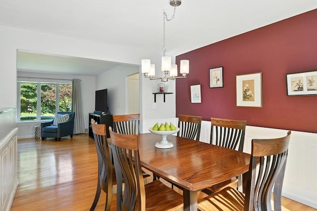 9 E Colonial Rd, Wilbraham, MA 01095 - dining room featuring a chandelier, light wood-style flooring, and an accent wall