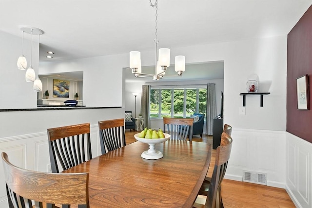 9 E Colonial Rd, Wilbraham, MA 01095 - dining area with wainscoting, a chandelier, and a decorative wall