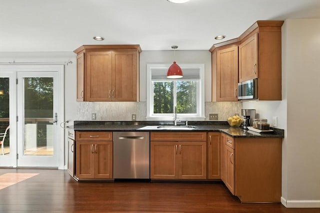 9 E Colonial Rd, Wilbraham, MA 01095 - kitchen with appliances with stainless steel finishes, dark wood-type flooring, decorative backsplash, recessed lighting, and decorative light fixtures