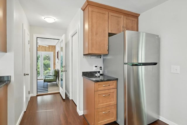 9 E Colonial Rd, Wilbraham, MA 01095 - kitchen with freestanding refrigerator, dark wood-style floors, dark stone countertops, and brown cabinetry