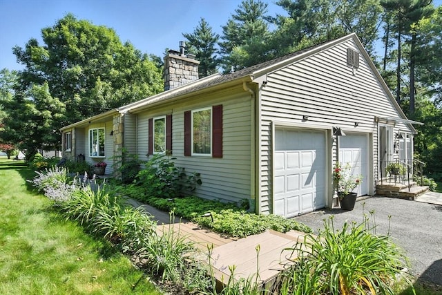 9 E Colonial Rd, Wilbraham, MA 01095 - view of side of property featuring a chimney, asphalt driveway, and an attached garage