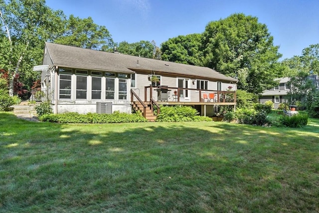 9 E Colonial Rd, Wilbraham, MA 01095 - back of property with a sunroom, a wooden deck, a lawn, and stairs
