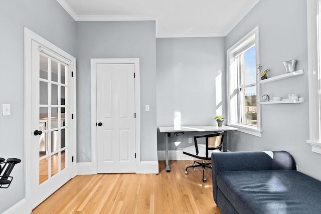 office space featuring baseboards, ornamental molding, and wood finished floors