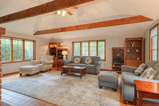 living area featuring healthy amount of natural light, ceiling fan, wood finished floors, and baseboards