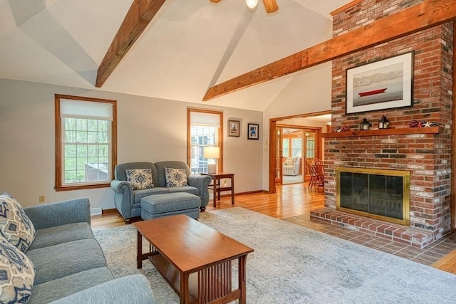 living room featuring beam ceiling, baseboards, a ceiling fan, high vaulted ceiling, and wood finished floors