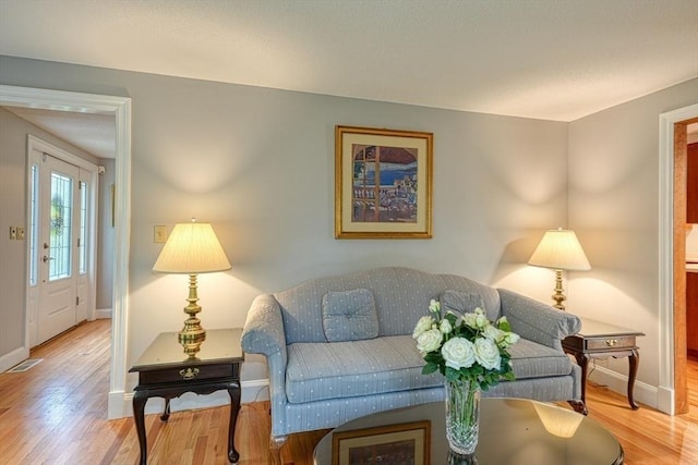 living area with wood finished floors and baseboards
