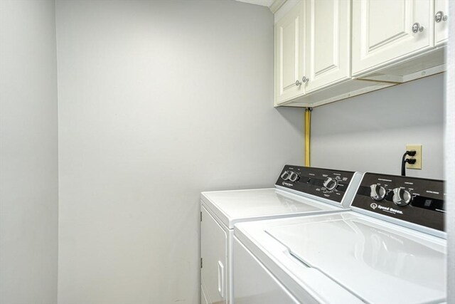 laundry area with washer and clothes dryer and cabinet space