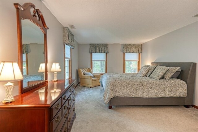 bedroom featuring light carpet