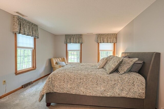 carpeted bedroom with baseboards