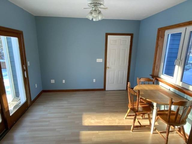 dining area with light hardwood / wood-style flooring and ceiling fan