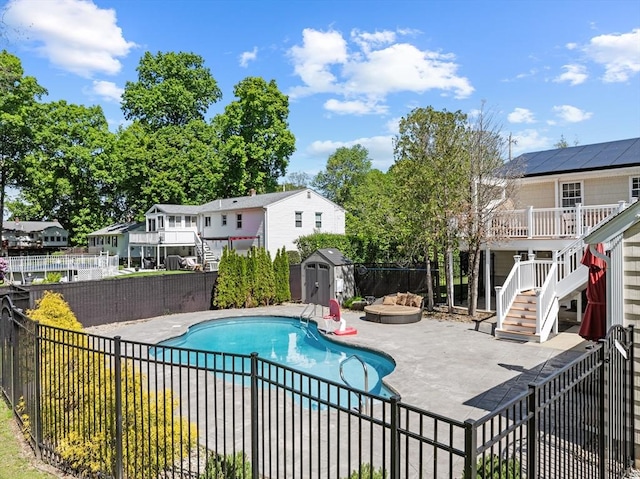 77 Columbus Dr, Fall River, MA 02720 - view of swimming pool featuring stairway, a fenced backyard, a patio area, a wooden deck, and a residential view
