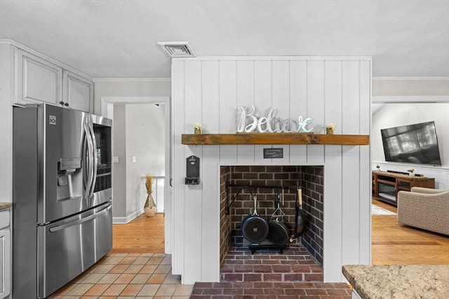 77 Columbus Dr, Fall River, MA 02720 - kitchen with stainless steel refrigerator with ice dispenser, crown molding, a fireplace, light stone countertops, and open shelves