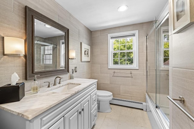 77 Columbus Dr, Fall River, MA 02720 - bathroom with baseboard heating, tile walls, vanity, toilet, and combined bath / shower with glass door