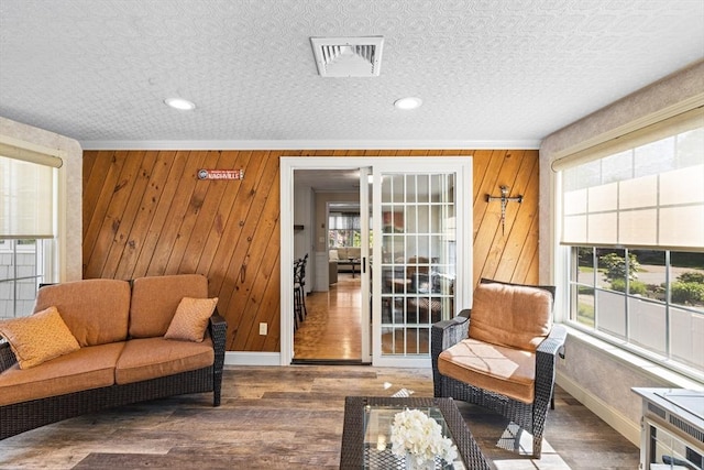 77 Columbus Dr, Fall River, MA 02720 - living area featuring baseboards, wood walls, wood finished floors, and crown molding