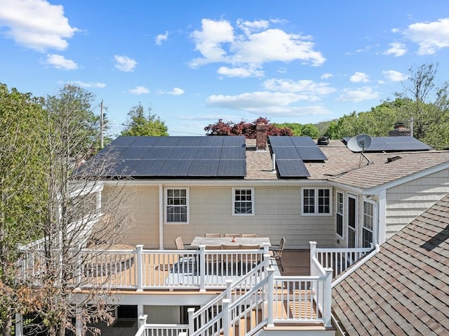 77 Columbus Dr, Fall River, MA 02720 - back of house with a shingled roof, a chimney, outdoor dining space, and a wooden deck
