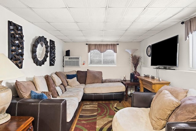 living room with a wall mounted AC and hardwood / wood-style flooring