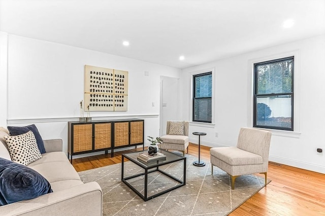 living room featuring baseboards, wood finished floors, and recessed lighting