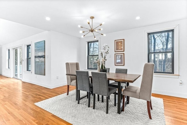 dining space with light wood finished floors, baseboards, a chandelier, and recessed lighting