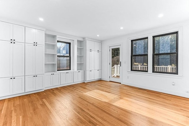 interior space with recessed lighting, visible vents, baseboards, access to outside, and light wood finished floors