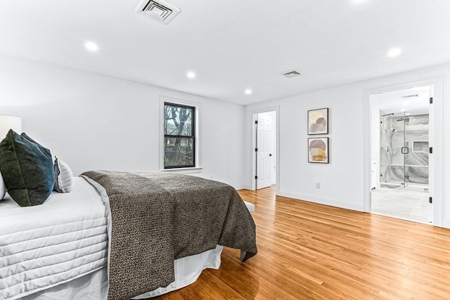 bedroom featuring light wood finished floors, visible vents, and recessed lighting