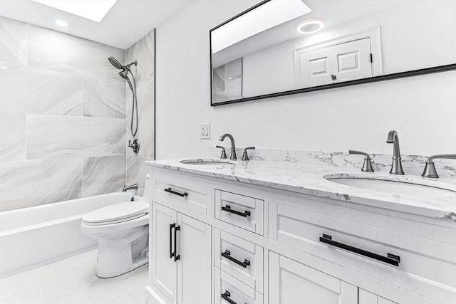 full bathroom featuring a sink, shower / bathing tub combination, toilet, and double vanity