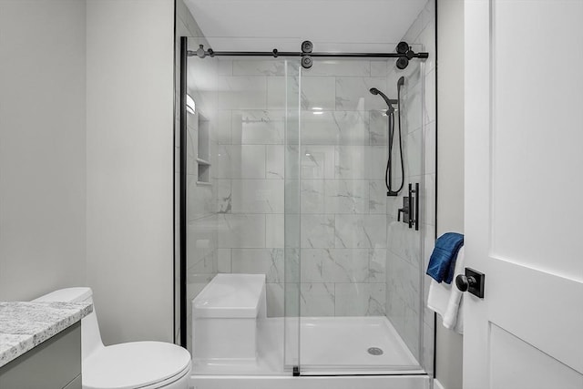 full bath featuring vanity, toilet, and a stall shower