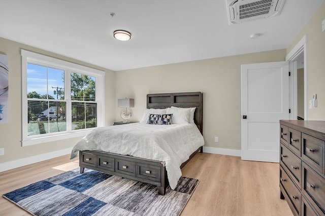 bedroom featuring visible vents, baseboards, and light wood-type flooring