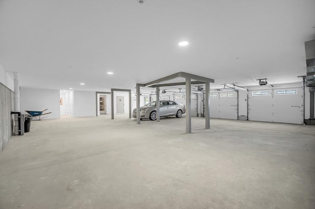 garage featuring recessed lighting and a garage door opener