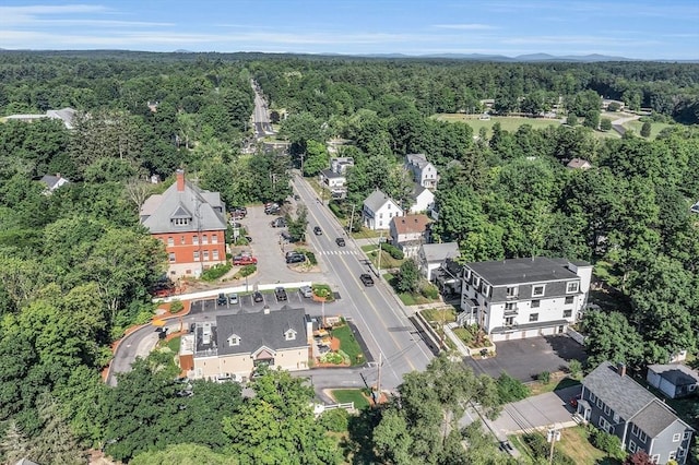 drone / aerial view with a wooded view