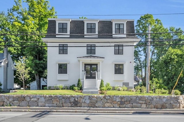 victorian home featuring a shingled roof, french doors, and mansard roof