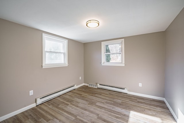 spare room featuring light hardwood / wood-style flooring and a baseboard heating unit