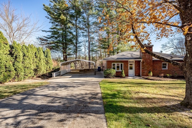 ranch-style house featuring a front lawn and a carport