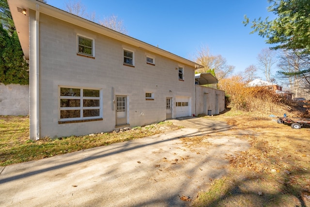 back of property featuring a garage