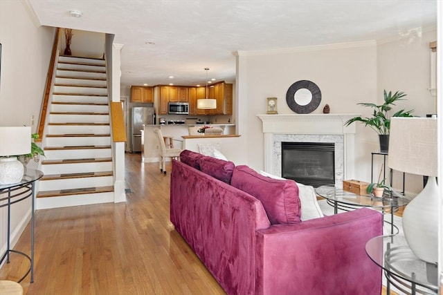 57 Alma Ave Unit 57, Belmont, MA 02478 - living area with light wood finished floors, stairway, crown molding, a premium fireplace, and recessed lighting