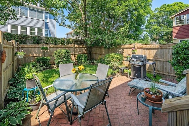 57 Alma Ave Unit 57, Belmont, MA 02478 - fenced backyard with a grill, a patio, and outdoor dining space
