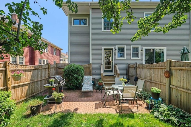 57 Alma Ave Unit 57, Belmont, MA 02478 - rear view of property featuring a patio area, entry steps, and a fenced backyard