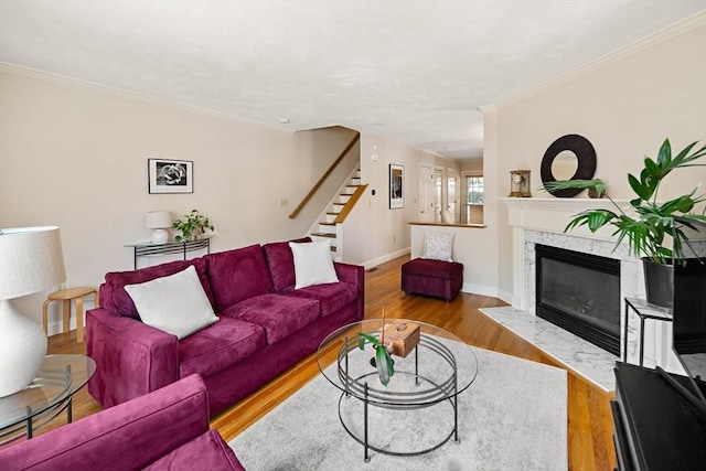 57 Alma Ave Unit 57, Belmont, MA 02478 - living room with a premium fireplace, wood finished floors, ornamental molding, and stairs