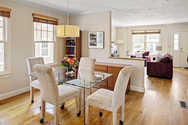 57 Alma Ave Unit 57, Belmont, MA 02478 - dining room featuring plenty of natural light, light wood finished floors, and ornamental molding
