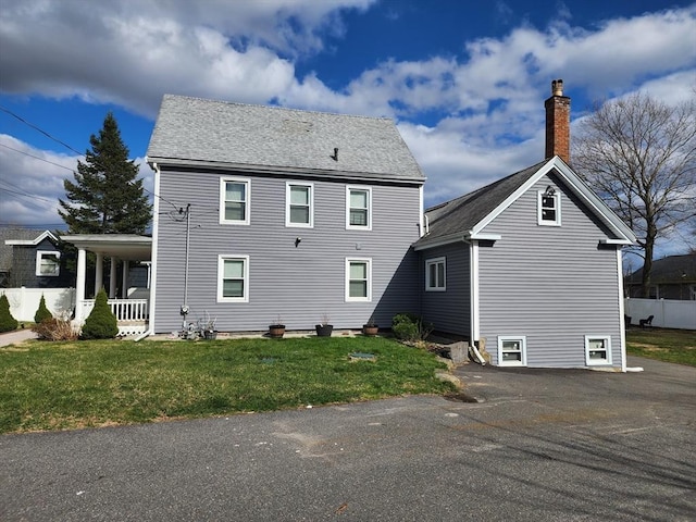 6 Pond St, Avon, MA 02322 - rear view of house featuring a chimney, covered porch, and a lawn