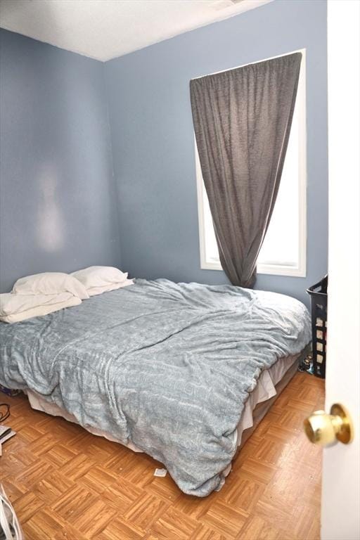 bedroom with light parquet flooring