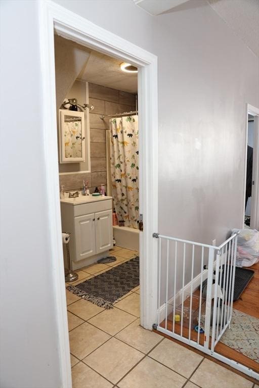 bathroom featuring tile patterned floors, shower / tub combo, and vanity