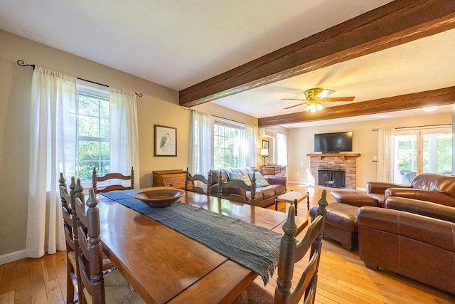 495 Creek St, Wrentham, MA 02093 - dining space featuring light wood-style flooring, a brick fireplace, beamed ceiling, baseboards, and ceiling fan