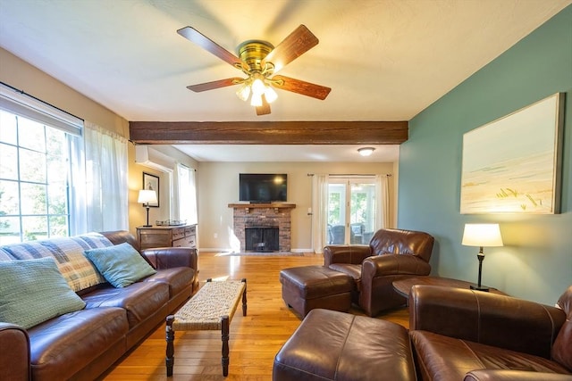 495 Creek St, Wrentham, MA 02093 - living room with light wood-style flooring, a ceiling fan, beam ceiling, a brick fireplace, and baseboards