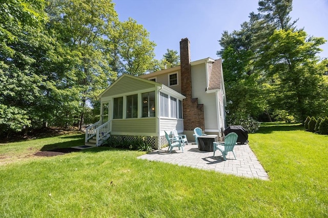 495 Creek St, Wrentham, MA 02093 - back of property featuring a patio, a chimney, a sunroom, a yard, and a fire pit