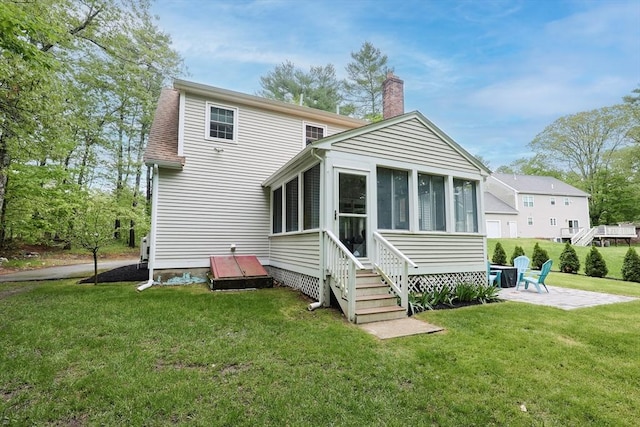 495 Creek St, Wrentham, MA 02093 - back of property with a chimney, a patio area, a sunroom, and a lawn